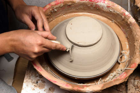 hands of a potter, creating an earthen jar on the circleの写真素材