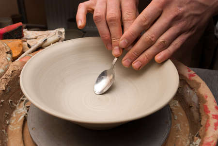 hands of a potter, creating an earthen jar on the circleの写真素材