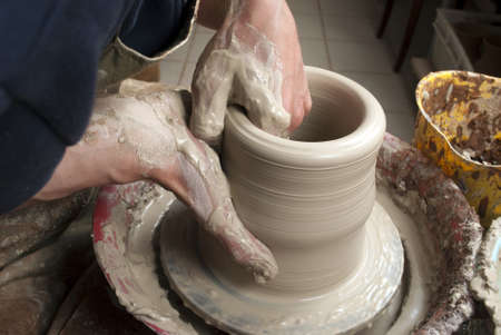 hands of a potter, creating an earthen jar on the circleの写真素材