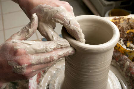 hands of a potter, creating an earthen jar on the circleの写真素材