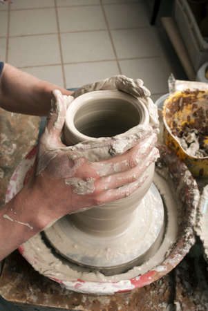 hands of a potter, creating an earthen jar on the circleの写真素材