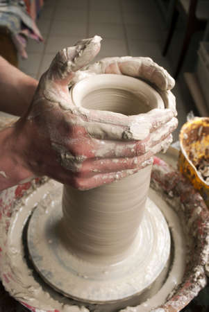 hands of a potter, creating an earthen jar on the circleの写真素材