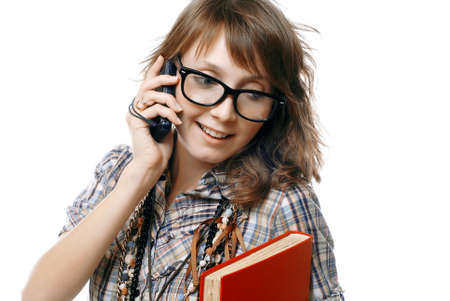 talking girl holds phone and red bookの写真素材