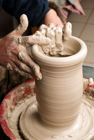 hands of a potter, creating an earthen jar on the circleの写真素材