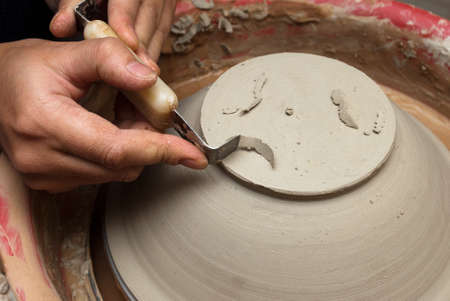 hands of a potter, creating an earthen jar on the circleの写真素材