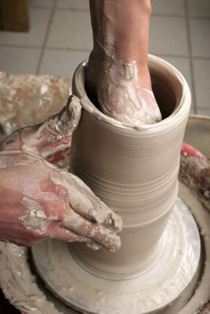 hands of a potter, creating an earthen jar on the circleの写真素材