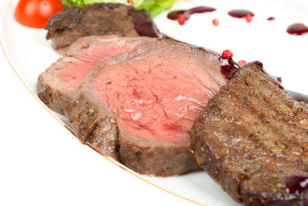 Grilled meat sliced on a plateの写真素材