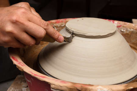 hands of a potter, creating an earthen jar on the circleの写真素材