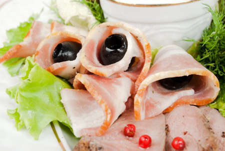 sliced bacon with olivesの写真素材
