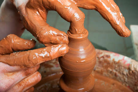 hands of a potter, creating an earthen jar on the circleの写真素材