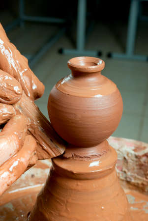 hands of a potter, creating an earthen jar on the circleの写真素材
