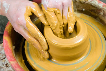 hands of a pohands of a potter, creating an earthen jar on the circletter, creating an earthen jar on the circleの写真素材