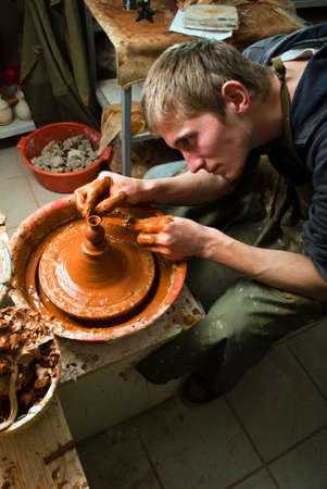 hands of a potter, creating an earthen jar on the circleの写真素材
