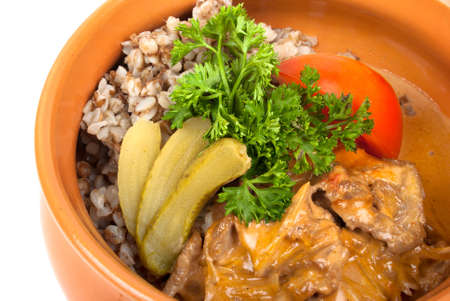 Meat with buckwheat cereal baked in a potの写真素材