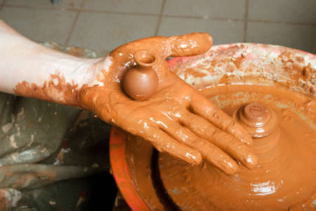 hands of a potter, creating an earthen jar on the circleの写真素材