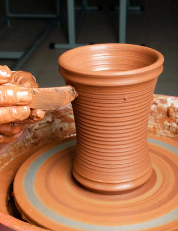 hands of a potter, creating an earthen jar on the circleの写真素材