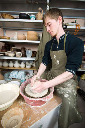hands of a potter, creating an earthen jar on the circleの写真素材