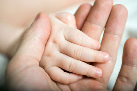 Image of newborn baby hand on the male handの写真素材
