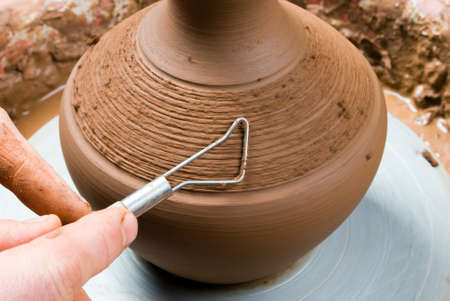 hands of a potter, creating an earthen jar on the circleの写真素材