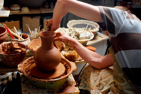 hands of a potter, creating an earthen jar on the circleのeditorial素材