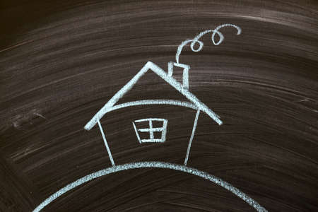 blackboard with a drowing of a houseの写真素材