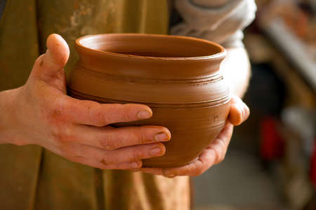 hands of a potter, creating an earthen jar on the circleの写真素材