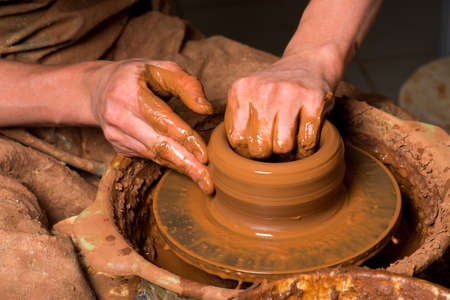 hands of a potter, creating an earthen jarの写真素材