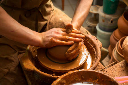 hands of a potter, creating an earthen jarの写真素材