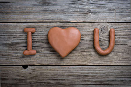I love you. clay installation on wood backgroundの写真素材