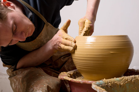 hands of a potter, creating an earthen jar