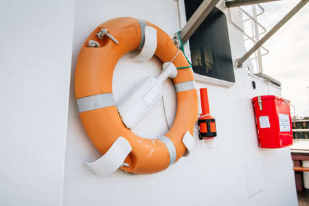 Orange lifebuoy on a white yacht sideの写真素材
