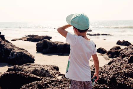 boy looking at oceanの写真素材