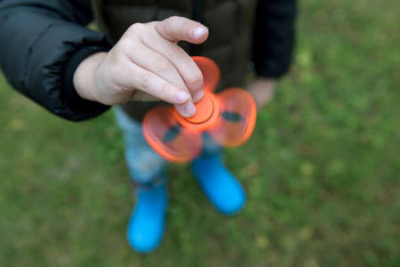 Two boys playing fidget spinners. Outdoorの写真素材