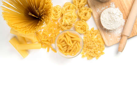 Different kinds of pasta on a white background. Farfalle, fettuccine, noodles, fusilli and penne rigate.の写真素材