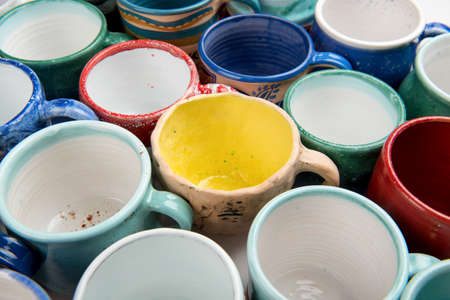 Hand-made ceramic cups in multicolor glaze.の写真素材