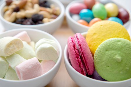 Different color sweets on bowl.