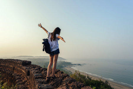 Girl tourist on mountain with backpack.