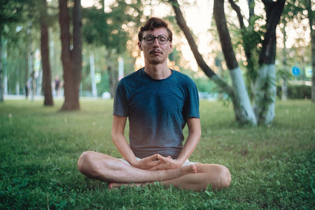 Man practicing meditation in cityの写真素材
