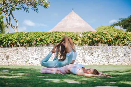 Pair of girls practice yogaの写真素材