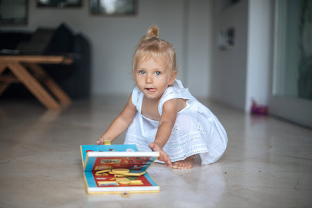 Three years old girl play on floor.の写真素材