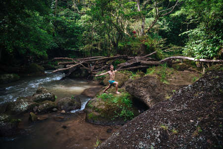 Yoga practice and meditation in nature. Man practicing near river.の写真素材