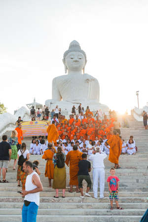 Young buddhists in orange clothes near the Big Buddha Temple in Phuket in Thailand. April 28, 2019.のeditorial素材
