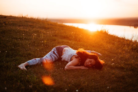 Yoga practice and meditation in nature in sunrise. Woman practicing near big river Kama