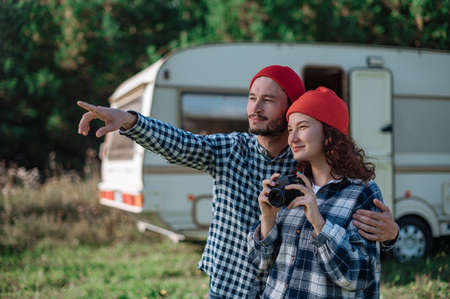 Romantic couple taking pictures of nature near the trailer at homeの写真素材