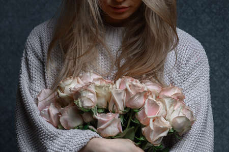 A woman with rose bouquet. High quality photoの写真素材