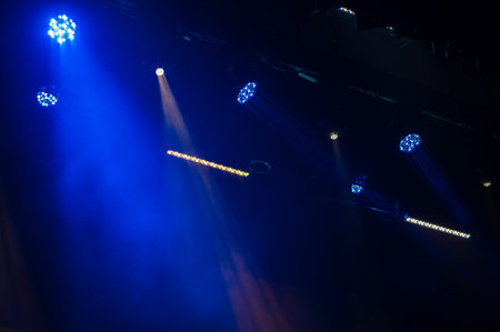 Multi-color light on dark stage in fog
