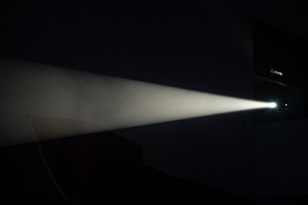 Multi-color light on dark stage in fogの写真素材