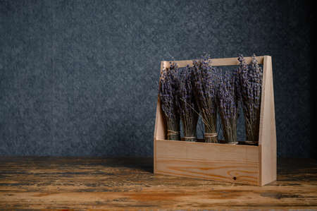Composition of dried flowers in a wooden basket on dark backgroundの写真素材