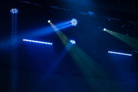 Multi-color light on dark stage in fogの写真素材