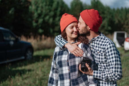 Romantic couple with a camera in nature near the trailer at home.の写真素材